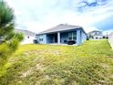 Spacious backyard with covered patio at 13447 Newport Shores Dr, Hudson, FL 34669