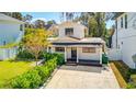 A charming house exterior with a white facade and a well-manicured lawn at 3912 W San Pedro St, Tampa, FL 33629