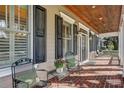 Inviting front porch with brick flooring, metal chairs, and lush flower pot at 804 S Fremont Ave, Tampa, FL 33606