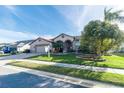 House exterior with palm trees and manicured lawn at 12528 Roseland Dr, New Port Richey, FL 34654