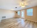 Bright living room featuring light wood-look floors and neutral walls at 12637 2Nd Isle, Hudson, FL 34667