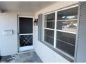 Charming front entryway with vintage mailbox, storm door, and a classic outdoor lantern at 7552 Cumber Dr, New Port Richey, FL 34653