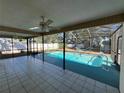 Enclosed pool area with patio and tiled floor at 1000 Godfrey Ave, Spring Hill, FL 34609