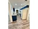 Modern kitchen with white cabinets, white appliances, and a stylish sink at 27173 Simona Ave, Brooksville, FL 34602