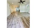 Spacious living room featuring wood-look floors and a ceiling fan at 27173 Simona Ave, Brooksville, FL 34602