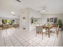 Bright dining area with wood table and chairs, open to living room at 2027 Beckwith Ave, Spring Hill, FL 34608