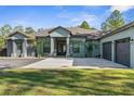 Charming single-story home with a well-manicured lawn and a double garage at 7376 Fall St, Brooksville, FL 34613