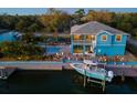 Waterfront property featuring a pool, boat lift, and expansive backyard at 7516 Gulf Way, Hudson, FL 34667