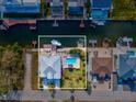 Bird's-eye view of waterfront home, pool, and boat slip at 7516 Gulf Way, Hudson, FL 34667