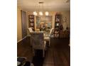 Dining room with hardwood floors, glass-top table, and built-in shelving at 140 Callaway Ave, Spring Hill, FL 34606