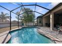 Inviting screened pool with ample patio space for relaxation at 692 Challice Dr, Spring Hill, FL 34609