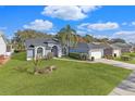 Single-story house with a large backyard, palm trees, and driveway at 8835 Thoreau Pl, Hudson, FL 34667