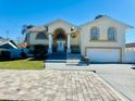 Two-story house with a large driveway and landscaping at 15806 Adobe Dr, Hudson, FL 34667