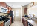 Well-lit kitchen with granite countertops, stainless steel appliances, and ample cabinet space at 6334 Timberly Ln, Zephyrhills, FL 33542