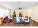 Inviting living room with wood floors, neutral walls, and plenty of natural light at 6334 Timberly Ln, Zephyrhills, FL 33542