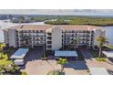Waterfront condo building with parking and lush landscaping at 8150 Brent St # 746, Port Richey, FL 34668