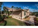 Tan house with walkway and landscaping at 9609 Brookdale Dr, New Port Richey, FL 34655