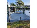 Spacious waterfront dock with seating area at 1050 Tamarac Dr, Holiday, FL 34690