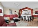 Open concept living and kitchen area with a breakfast bar and hardwood floors at 11617 Boynton Ln, New Port Richey, FL 34654