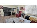 Living room with a large TV, comfortable seating, and hardwood floors at 11617 Boynton Ln, New Port Richey, FL 34654