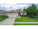 One story house with a large front yard and driveway at 13455 Niti Dr, Hudson, FL 34669