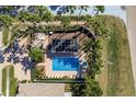 Top-down view of a community pool with surrounding landscaping and patio at 14120 Whitecap Ave, Hudson, FL 34667
