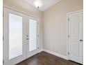 Bright entryway with double doors, hardwood floor, and a coat closet at 3470 Cedar Crest Loop, Spring Hill, FL 34609