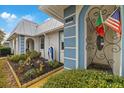 Landscaped garden and front entry of the house with decorative accents at 4231 Richmere Dr # 3D, New Port Richey, FL 34652