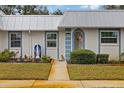 Front entry of house with walkway, landscaping, and religious statue at 4231 Richmere Dr # 3D, New Port Richey, FL 34652