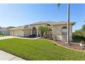 This charming home boasts a lush lawn and a three-car garage at 7302 Melogold Cir, Land O Lakes, FL 34637