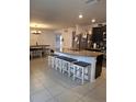 Spacious kitchen with an island, granite countertops, and stainless steel appliances at 8278 Silverbell Loop, Brooksville, FL 34613