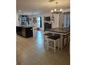 Open kitchen with large island, breakfast bar, and ample cabinet space at 8278 Silverbell Loop, Brooksville, FL 34613