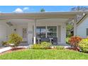 Front porch with seating area and well-maintained landscaping at 10620 Salamanca Dr, Port Richey, FL 34668