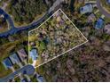 Aerial view of a property with surrounding houses and lot line at 11509 Sinatra Ct, New Port Richey, FL 34654