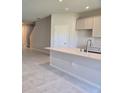 Kitchen island with white cabinets and quartz countertops at 12466 Amber Creek Cir, Lakewood Ranch, FL 34211