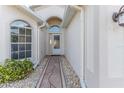 Front entry with a white door and stone pathway at 262 Hartford Ct, Spring Hill, FL 34609