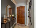 Entryway with a wooden door, mirror, and console table at 29703 69Th N St, Clearwater, FL 33761