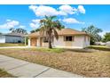 Landscaped yard with a single-story house and attached garage at 5461 Colchester Ave, Spring Hill, FL 34608