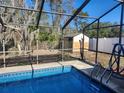 Refreshing blue pool with a screened enclosure at 6141 Freeport Dr, Spring Hill, FL 34606
