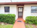 Front entrance with a walkway and landscaping at 7805 Radcliffe Cir # 7805, Port Richey, FL 34668
