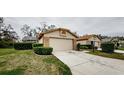 House exterior showcasing a garage and manicured lawn at 10030 Brookdale Dr, New Port Richey, FL 34655