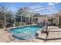 Screened pool area with fountain and lounge chairs at 10124 Southern Breeze Ct, Weeki Wachee, FL 34613
