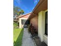 Side view of villa showing walkway and landscaping at 10736 Fiddlesticks Ct, New Port Richey, FL 34654