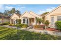 Exterior view of a charming villa with a manicured lawn at 11445 Orleans Ln, Port Richey, FL 34668