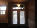 Interior double doors with sheer curtains and an arched window at 1855 Eau Claire Ct, Oldsmar, FL 34677