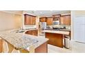 Modern kitchen with granite countertops, stainless steel appliances, and an island at 2902 Punta Palma Ct, Holiday, FL 34691