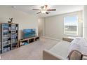 Spacious bonus room with a TV, couch, and built-in shelving at 313 Argyll Dr, Spring Hill, FL 34609