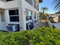 Exterior of condo unit showing windows, AC unit, and landscaping at 5142 Topaz Ln # 103, New Port Richey, FL 34652