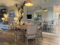 Condo dining area with round table, four chairs, and a view of the living room at 6734 Dali Ave # 206, Land O Lakes, FL 34637