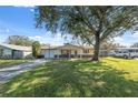 House exterior with a tree-lined yard and American flag at 6920 Medlar Dr, New Port Richey, FL 34653
